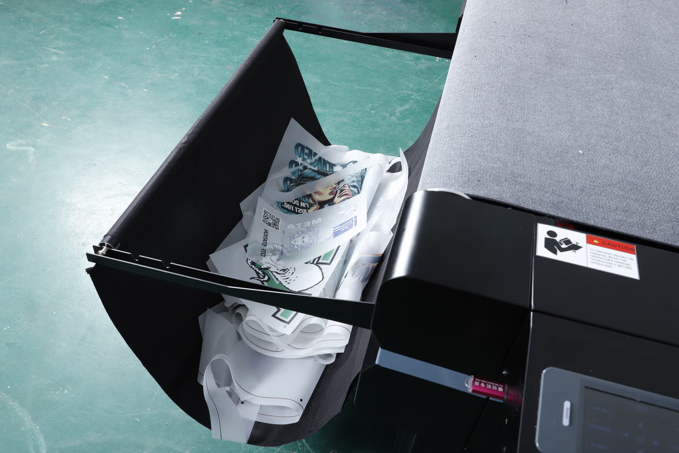 The collection basket of the Arc 127 with cut transfers in it