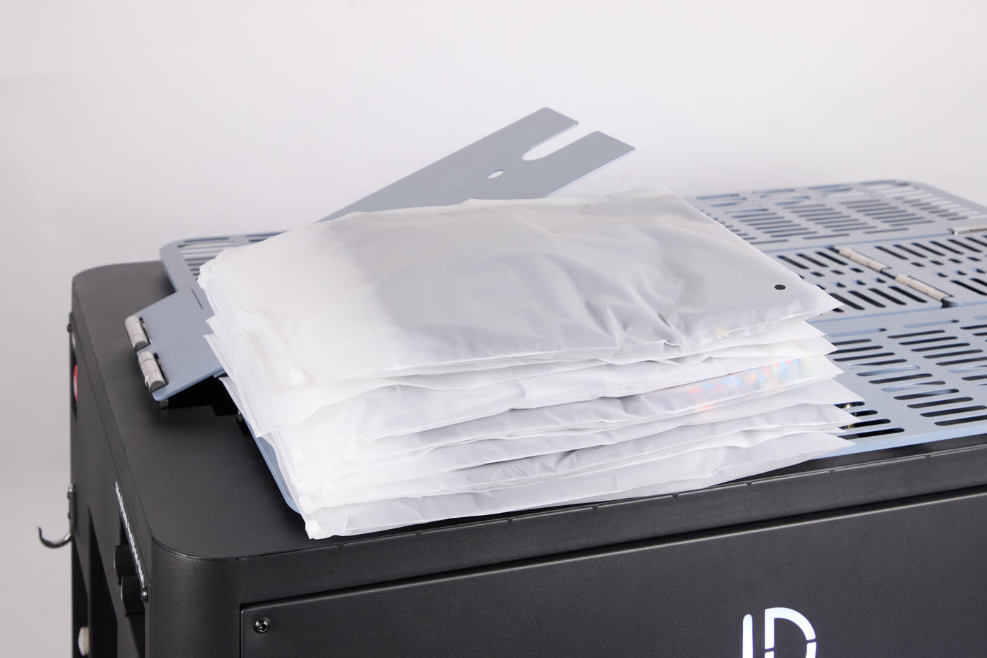 Folded and bagged garments stacked on the FoldFlex